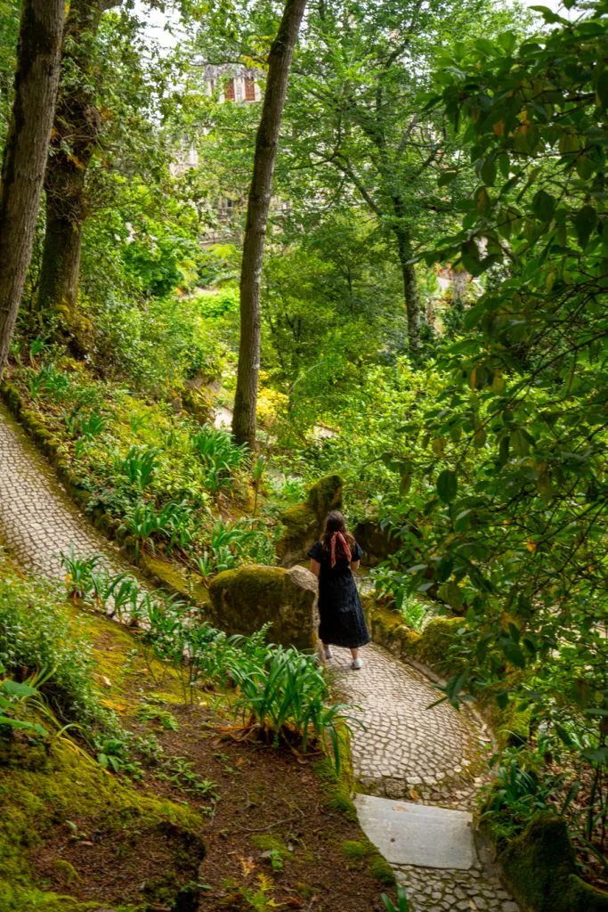 kate storm walking through the grounds of quinta da regaleira