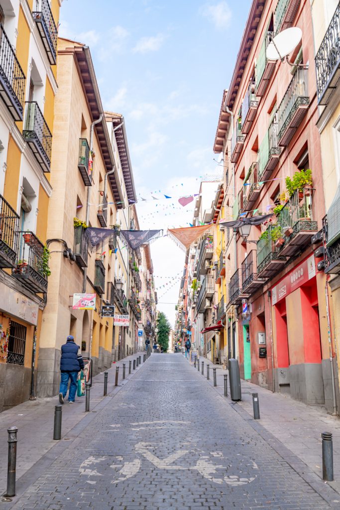 flags lining a colorful street as seen one day in toledo spain