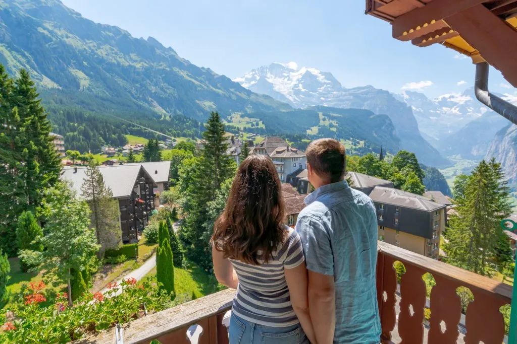 kate storm and jeremy storm overlooking a balcony in wengen switerland jungfrau region