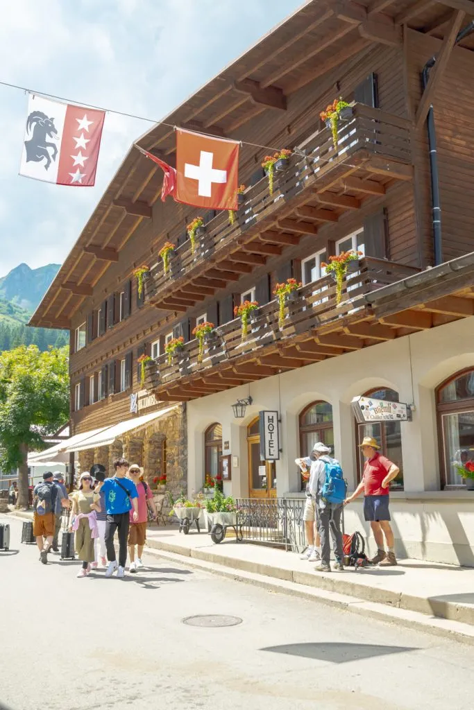 people walking through central murren switzerland in the summer