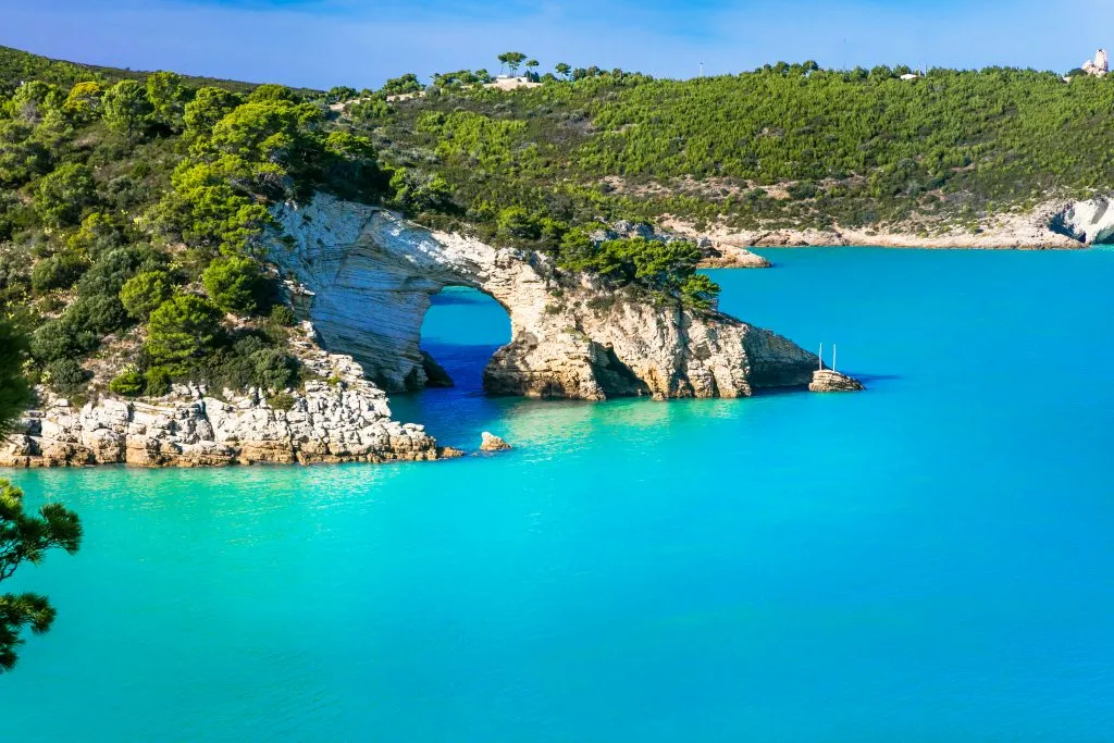 bright blue water with white cliffs in gargano national park puglia travel guide