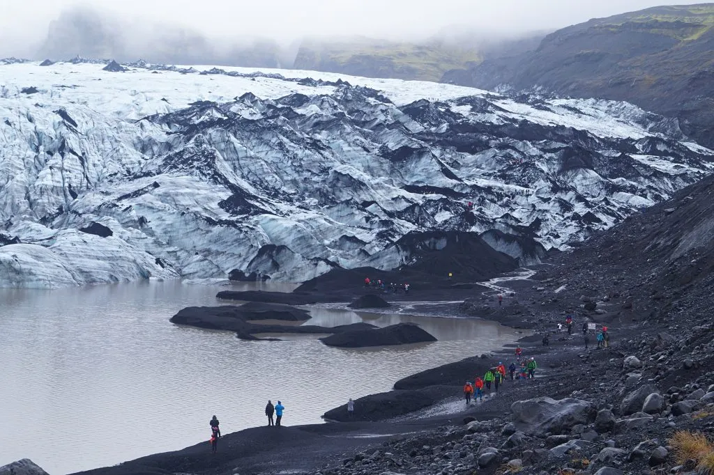 hikers approaching Sólheimajökull glacier in iceland