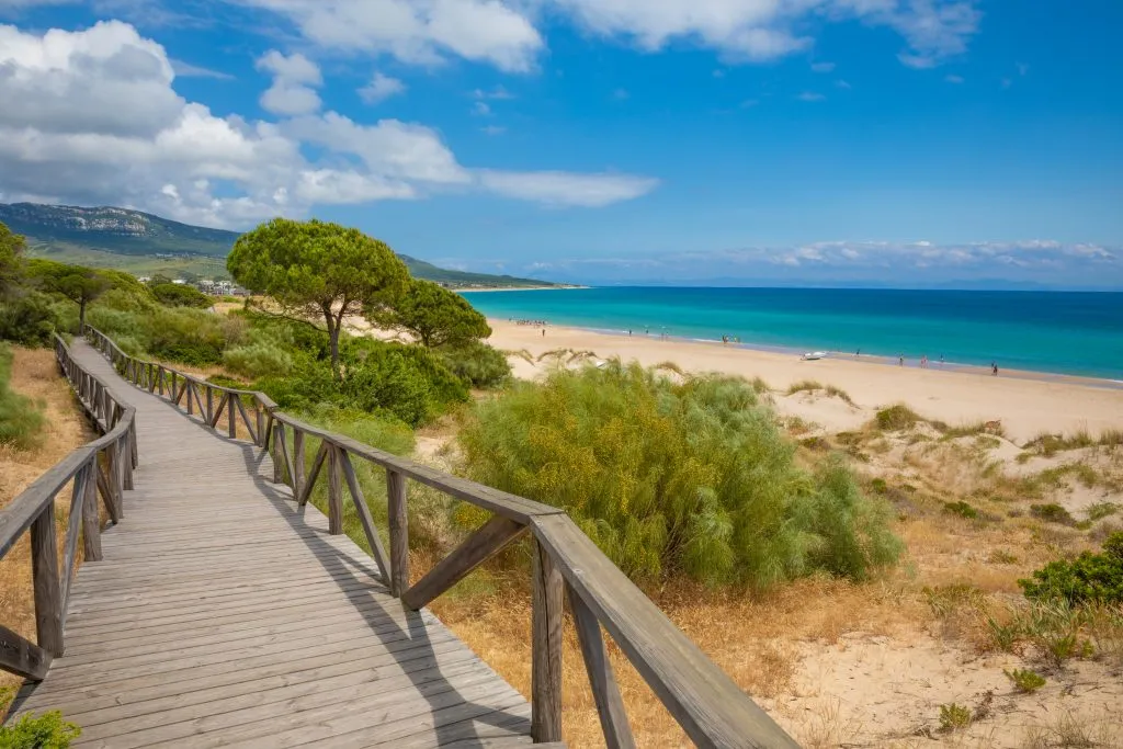 boardwalk along the sandy beach in tarifa, one of the best coastal towns in spain