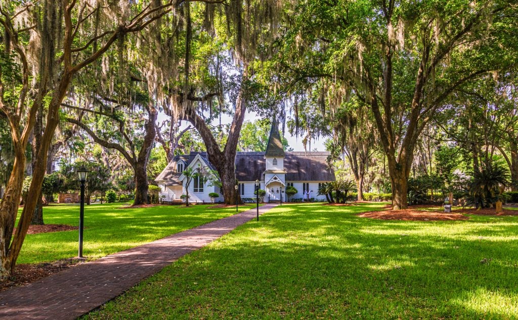 old christ church on st simons island georgia, as seen across a lush lawn