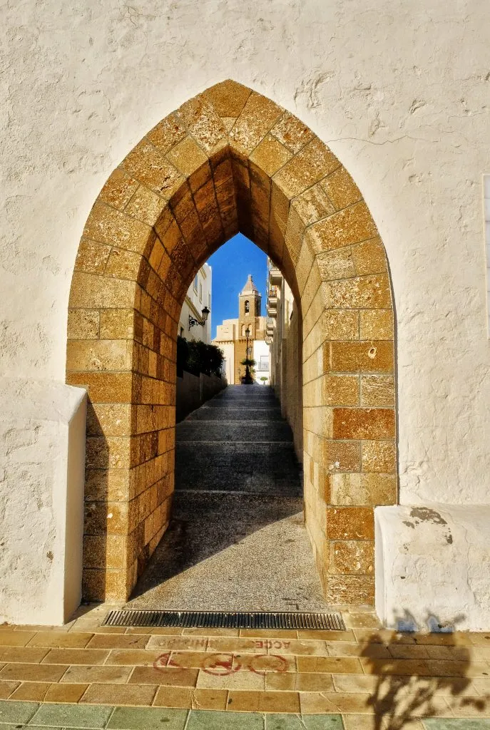 archway leading into historic center of rota, one of the best coastal towns in spain