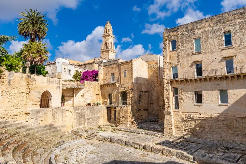 roman amphitheater in lecce italy with bell tower in the background