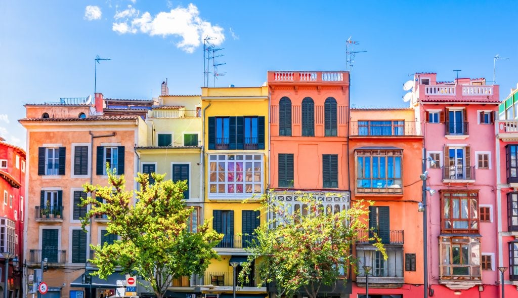 facades of colorful buildings in palma de mallorca, one of the best beach towns in spain
