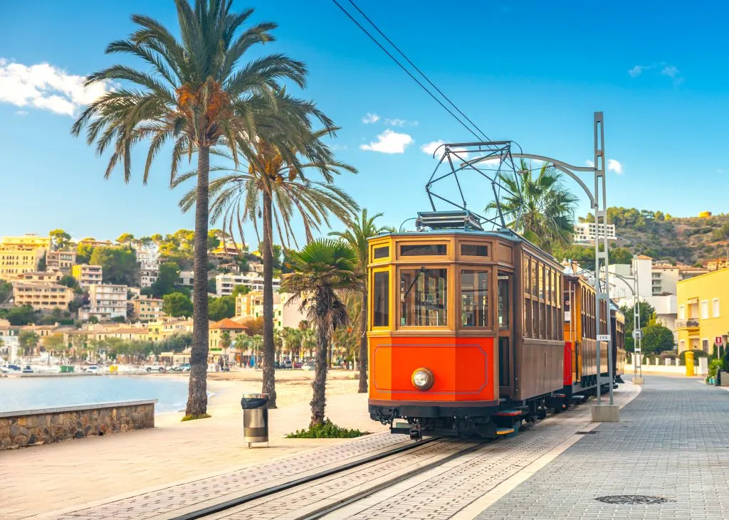 electric tram running along the beach in mallorca spain