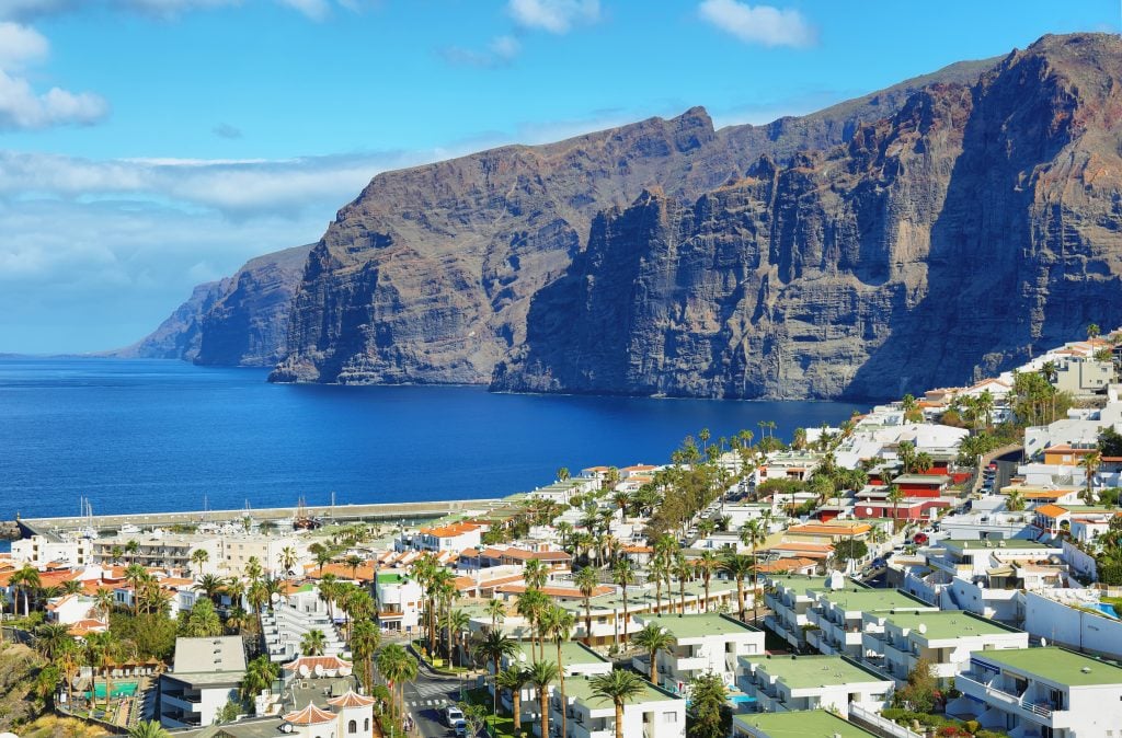 los gigantes spain with town in the foreground and cliffs in the background