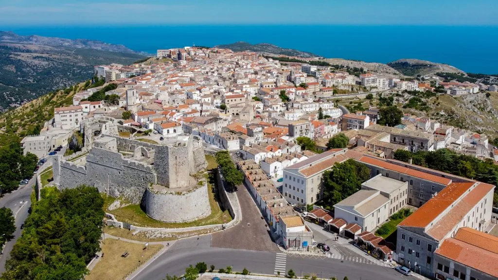 aerial view of monte sant'angelo puglia italy with castle in the foreground