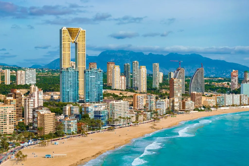 skyline of benidorm spain on costa blanca with water in the foreground, one of the best spain coastal cities to visit