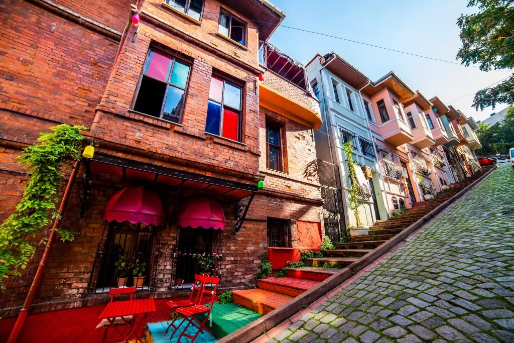 colorful houses set along a very steep stone street in balat turkey
