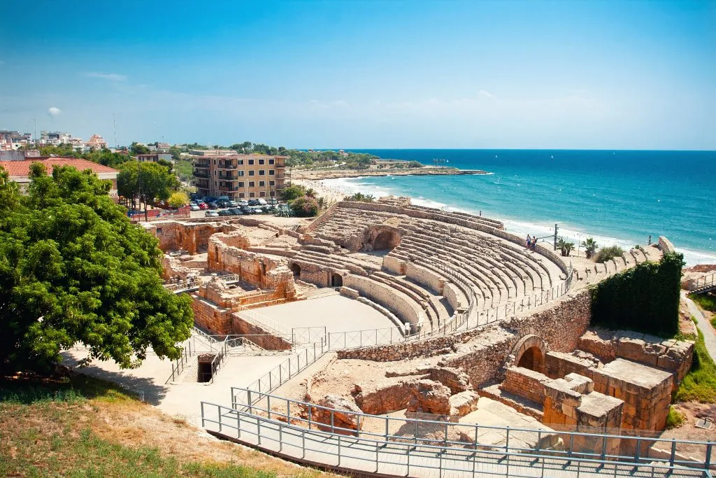 roman amphitheater in tarragona spain as seen from above with beach in background