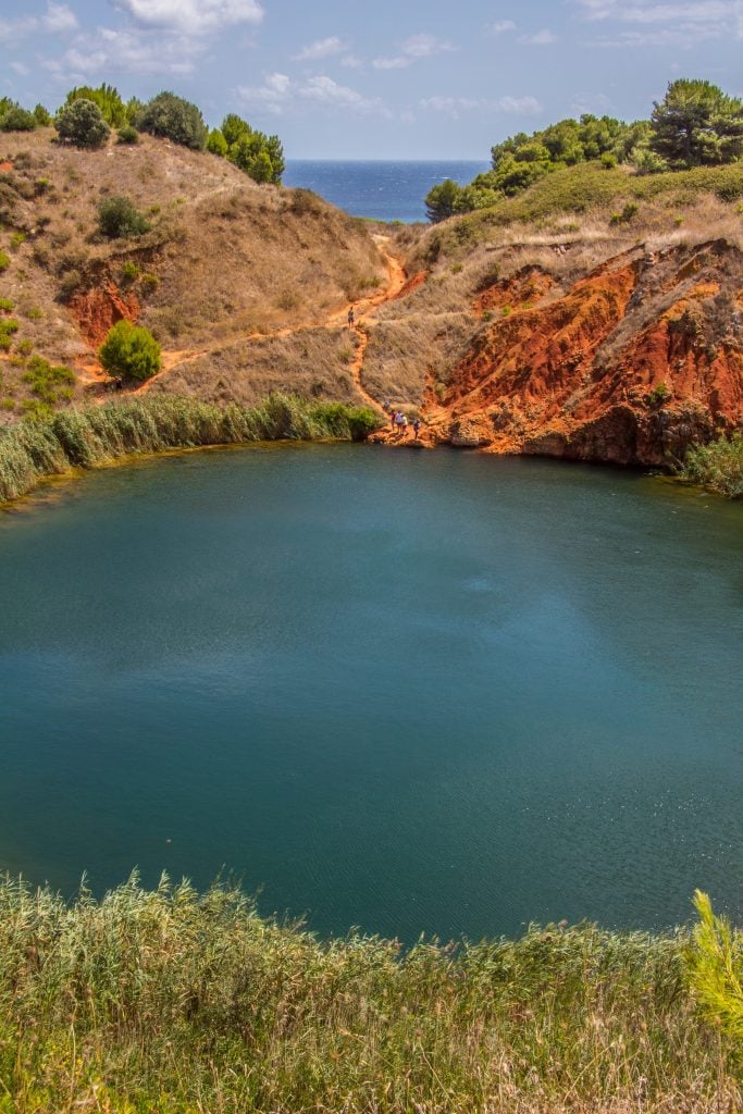 Cava di Bauxite surrounded by red rocks, one of the best things to do otranto puglia