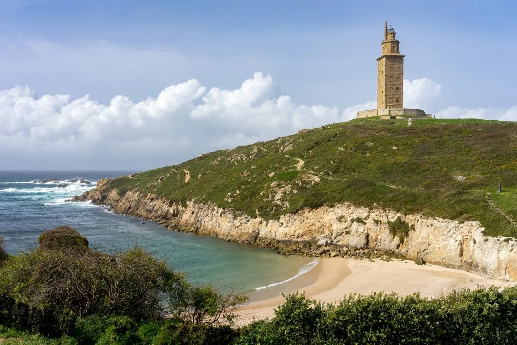 tower of hercules with beach in the foreground in galicia