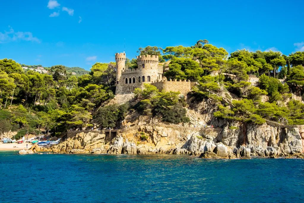 castle along the coast of catalonia as seen from the water