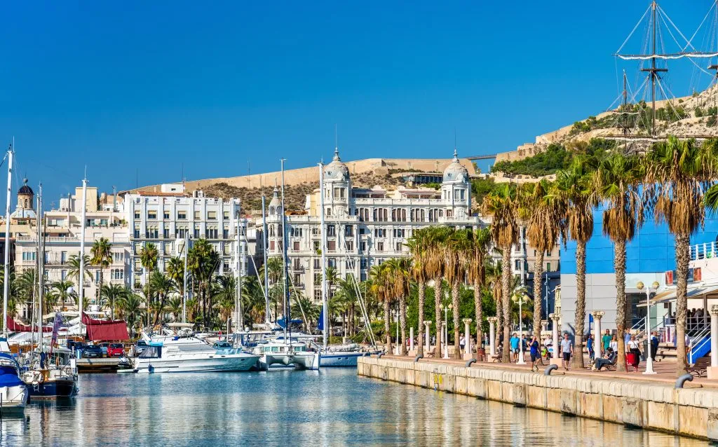 marina in alicante spain with water in the foreground, one of the best coastal cities in spain