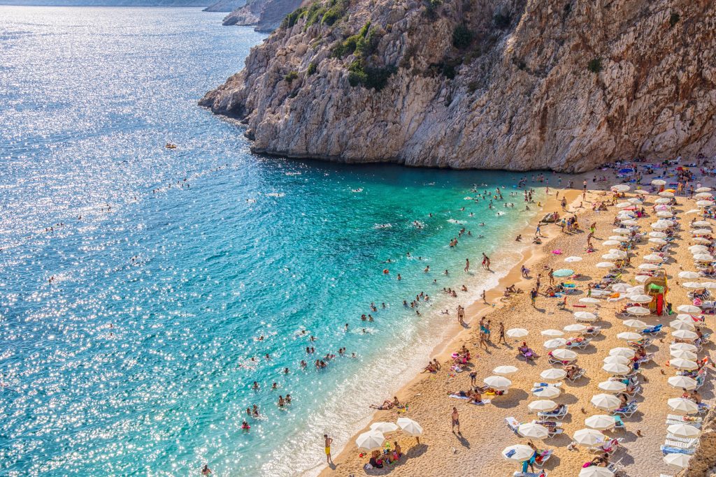 kaputas beach in antalya as seen from above with white umbrellas lining the beach, one of the most beautiful places in turkey to visit