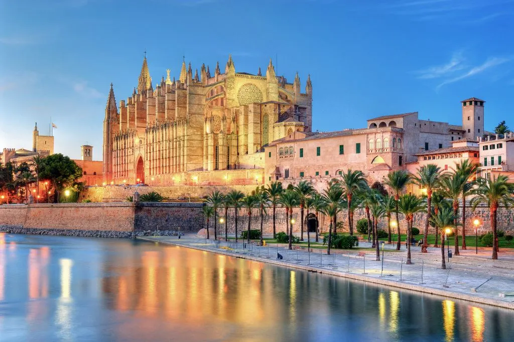 cathedral of palma de mallorca at night as seen from across the water
