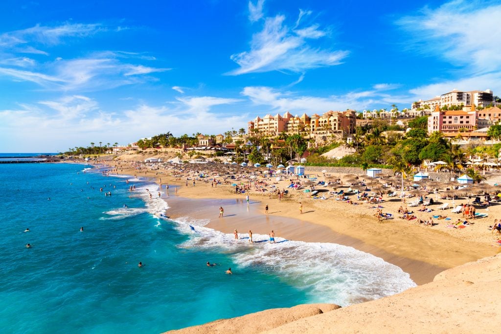 el duque beach at costa adeje, one of the most famous beach towns in spain's canary islands