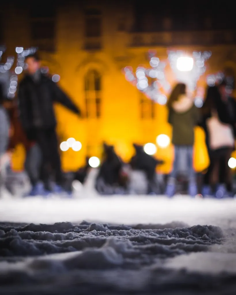 people ice skating at night in bruges winter