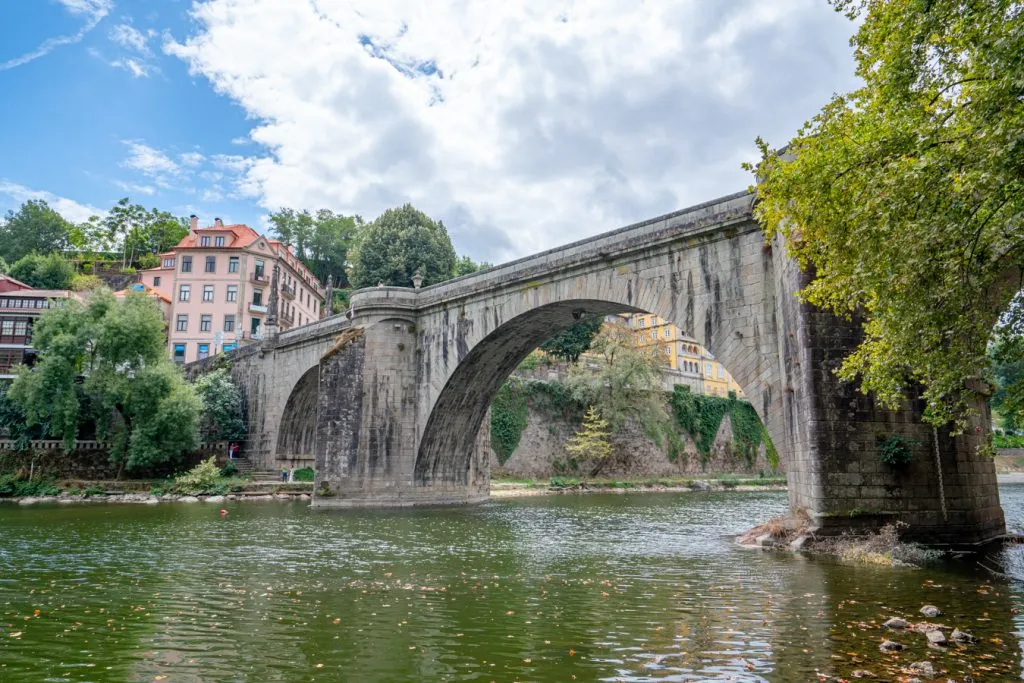 view of ponte de sao goncalo from the banks of the river, one of the best things to do in amarante portugal