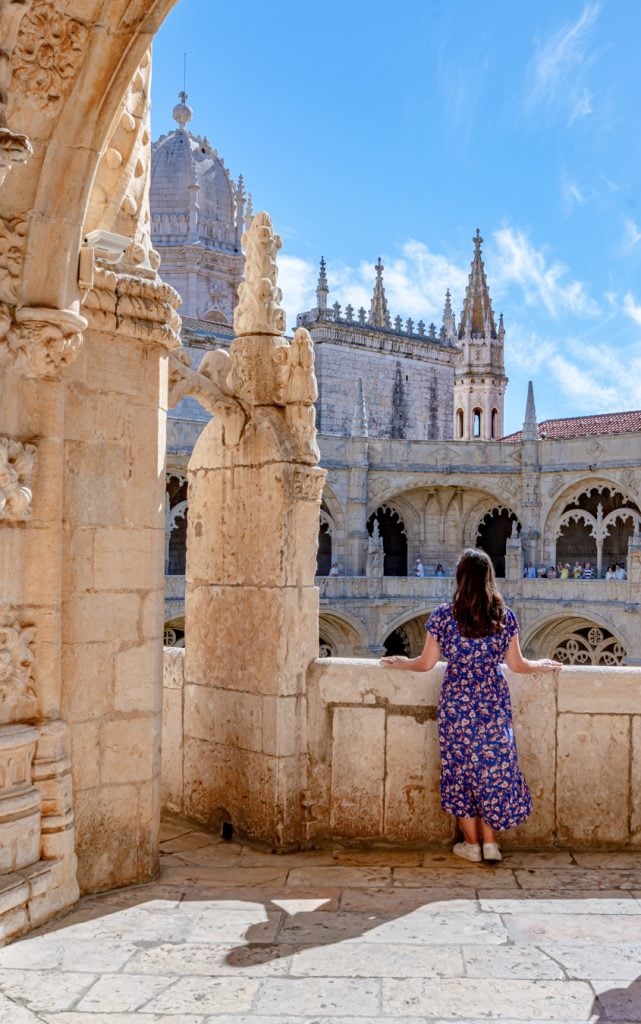 kate storm in a blue dress overlooking jeronimos monastery, one of the best things to do in lisbon portugal itinerary