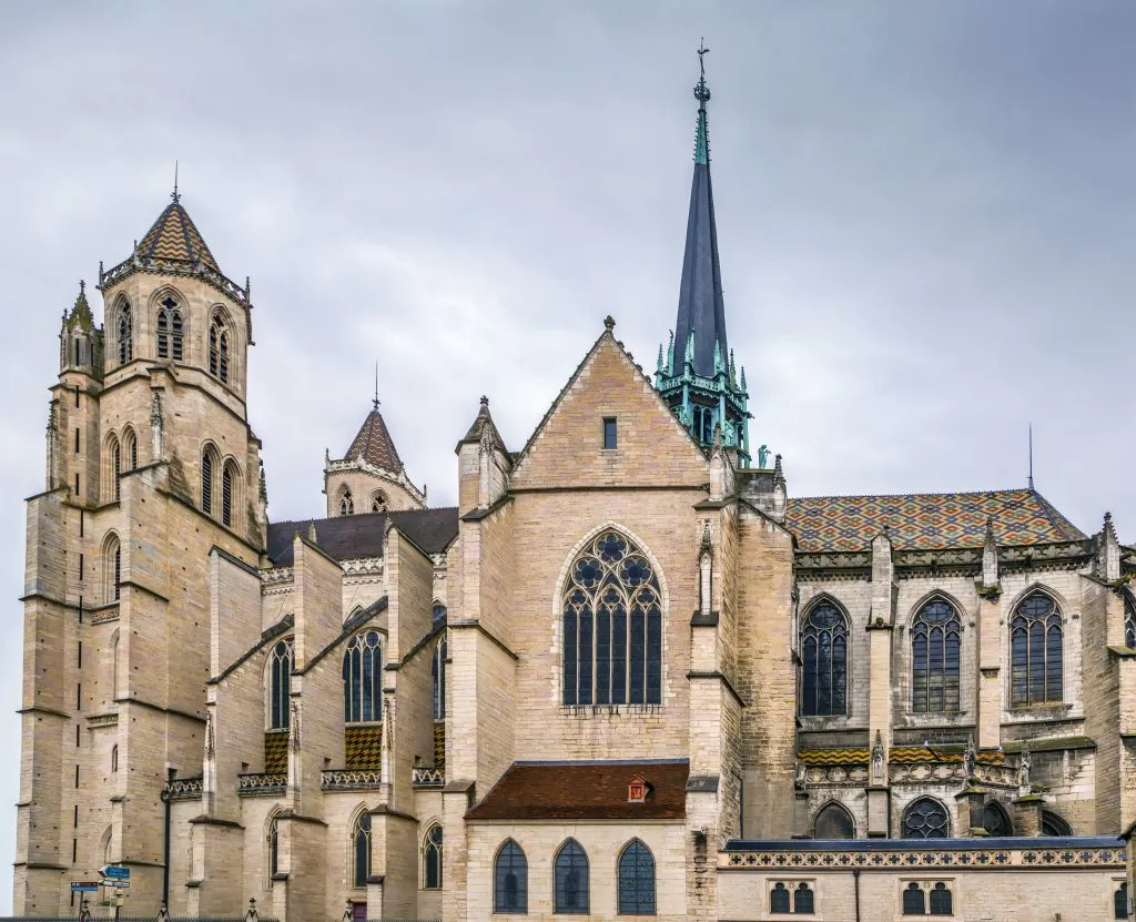 facade of dijon cathedral as seen from the side on a cloudy day