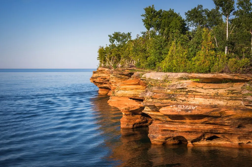 apostle islands national lakeshore as seen from the water at sunset