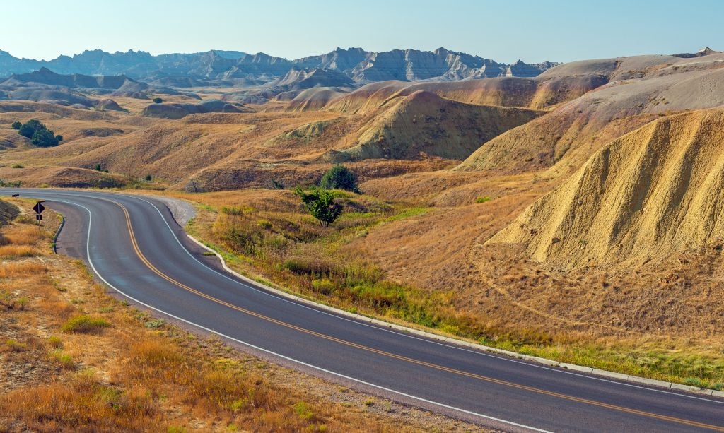 winding road through badlands national park