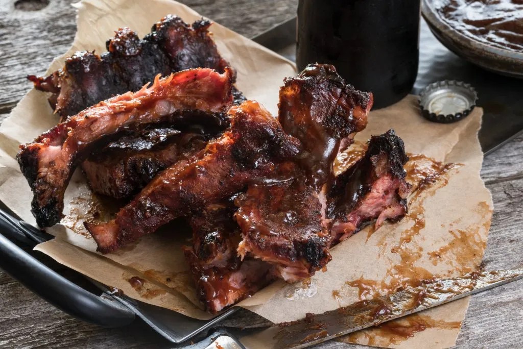 plate of smoked barbecue ribs in a restaurant