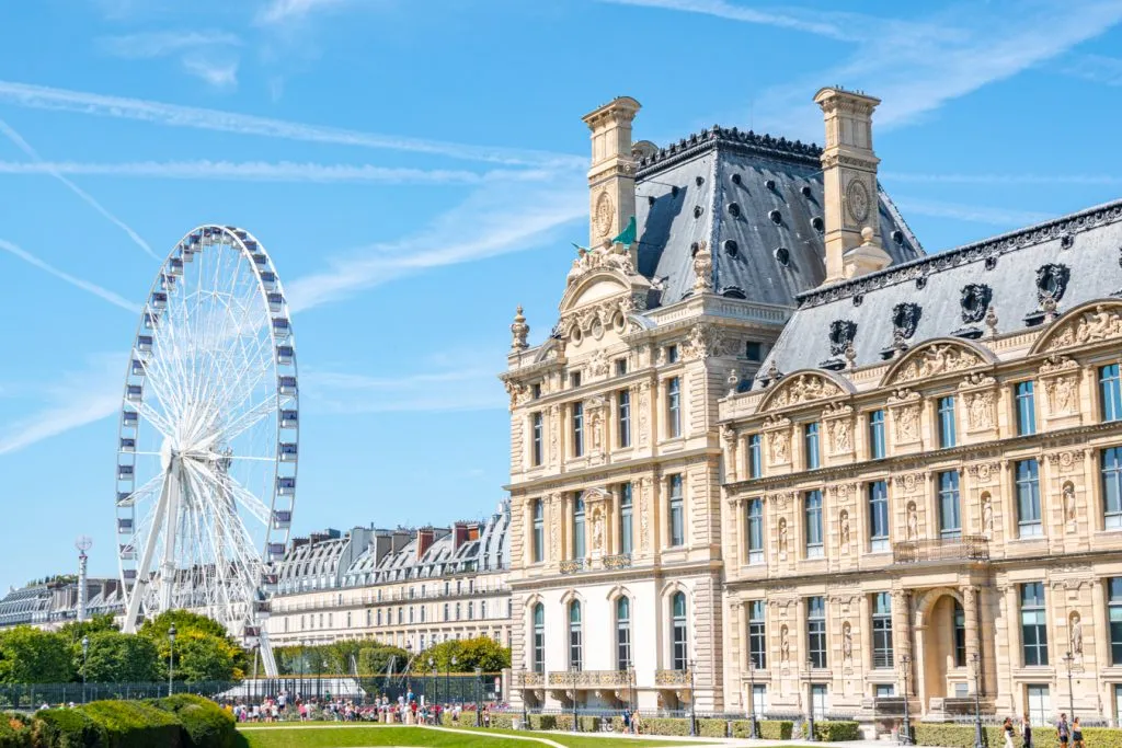 exterior of the louvre with ferris wheel in the background