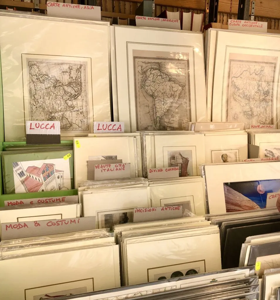 vintage maps for sale at an antique market in italy, as seen when shopping for things to collect while traveling
