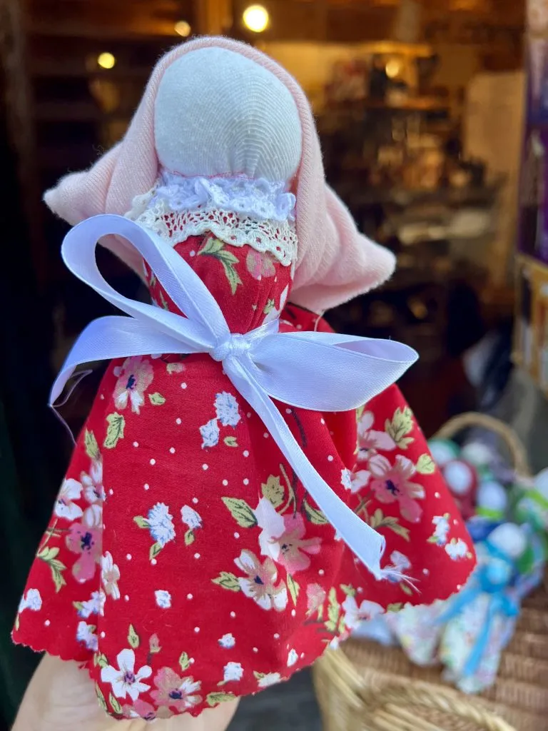 traditional fertility doll in monsanto portugal in a red dress
