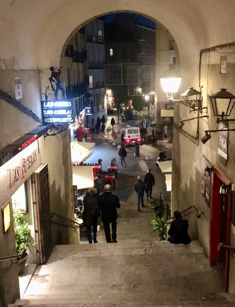 staircase leading out of plaza mayor past restaurants and tapas bars in madrid at night