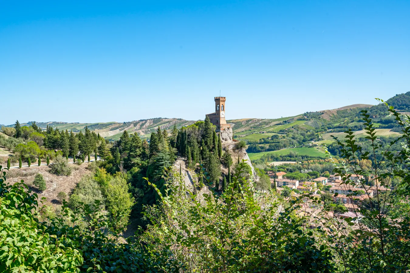 view of the clock tower of brisighella from a distance, a wonderful stop on a visit emilia romagna itinerary