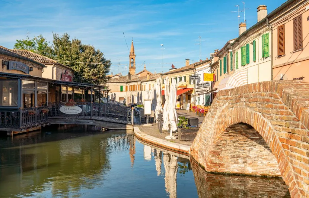 canal with bridge in comacchio emilia romagna italy, with reflections showing in the water
