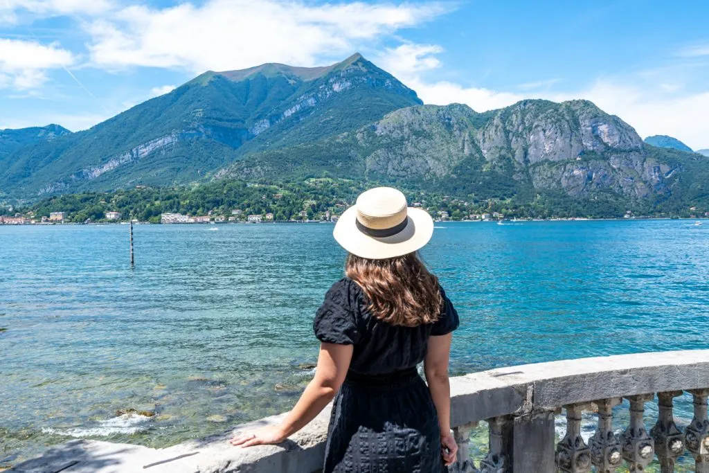 kate storm in a black dress overlooking lake como bellagio waterfront