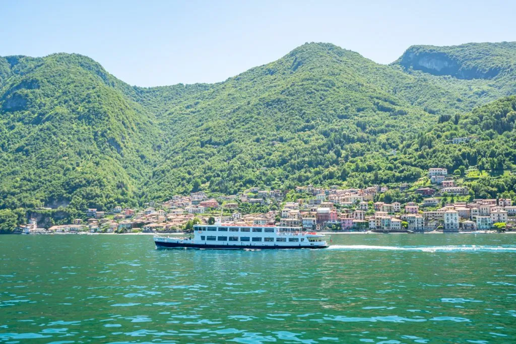 view of lake como italy with a ferry in the foreground