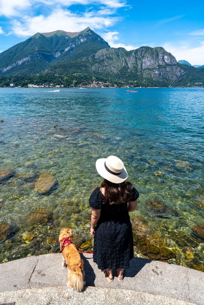 kate storm and ranger storm standing on the edge of the water in bellagio, a popular stop on a day trip to lake como from milan italy