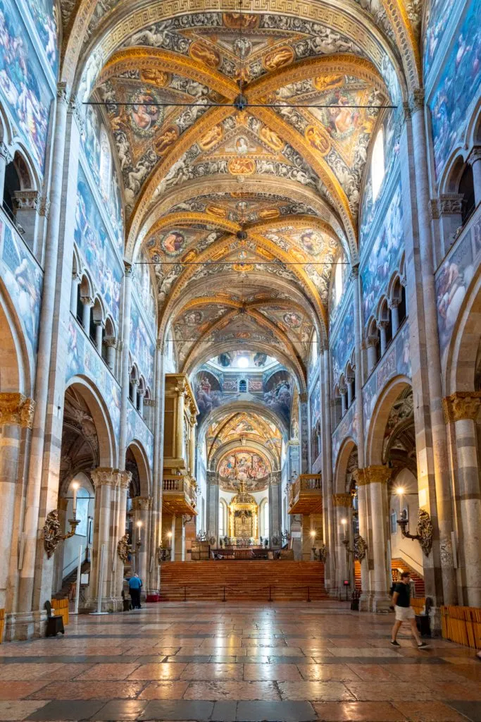 interior of the parma duomo with frescoed ceiling prominent, one of the best places to visit parma italy