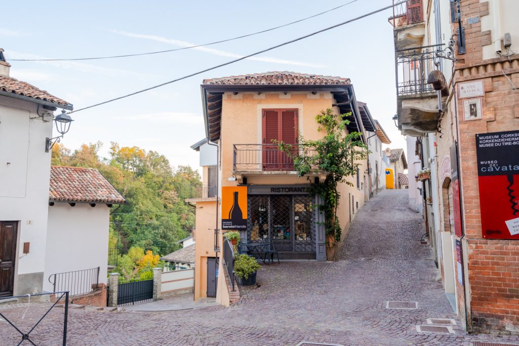 the small village of barolo italy with cobblestone streets in the foreground