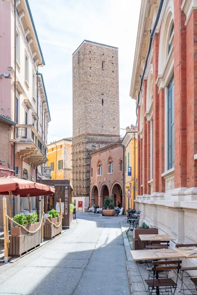 curving street in ravenna italy with tower centered in the shot