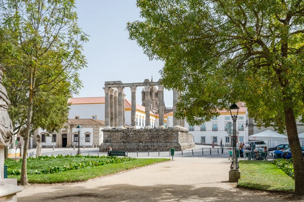 roman tuins of evora in the distance as seen through a park