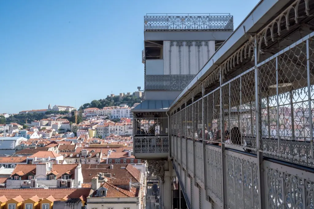 view of the top of the iron santa justa lift with the city in the background, a fun viewpoint on a 3 day lisbon itinerary