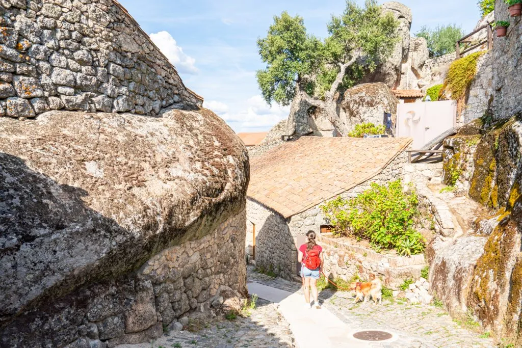 kate storm and ranger storm climbing amongst boulders in monsanto portugal rock village