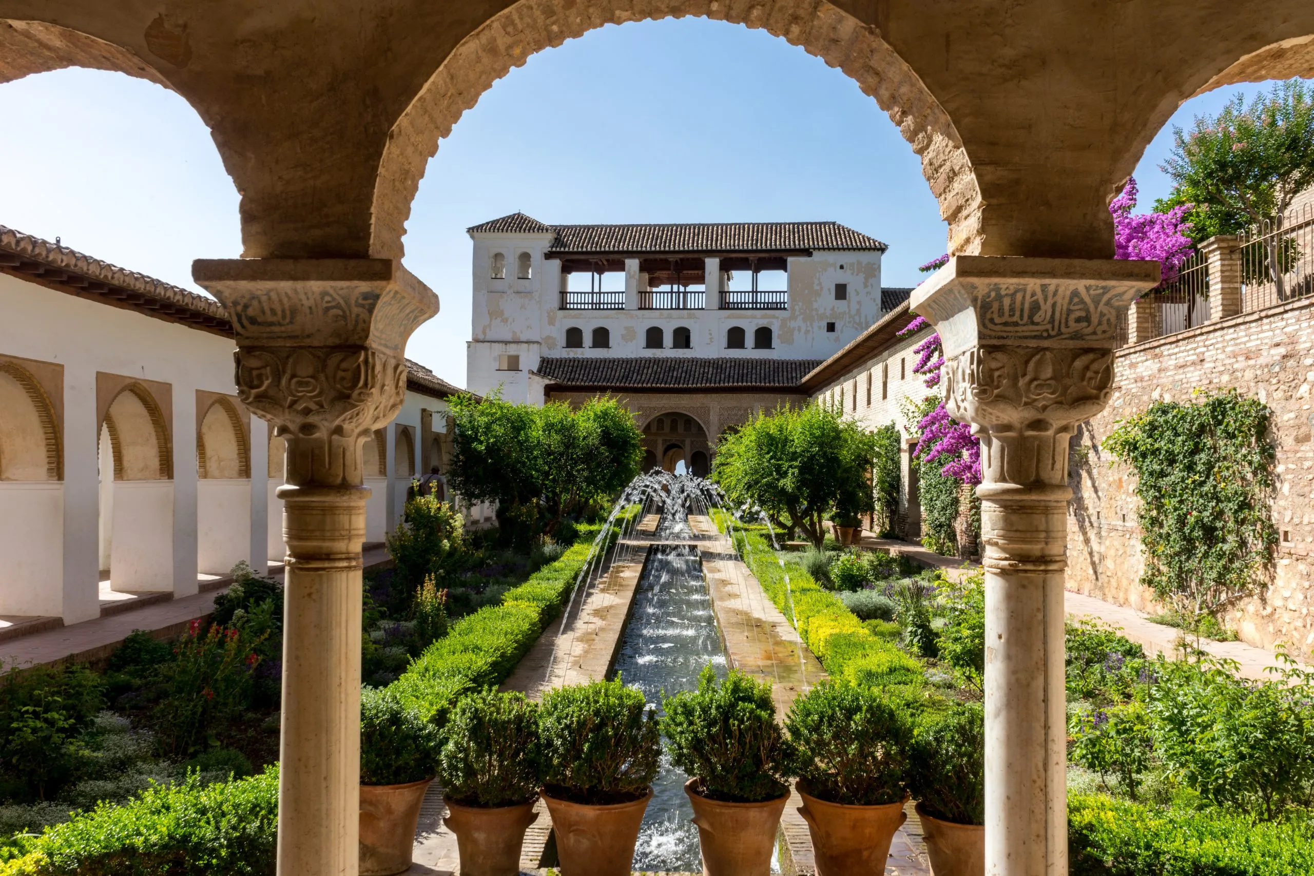 view of generalife gardens from inside courtyard, as seen when visiting the alhambra tips