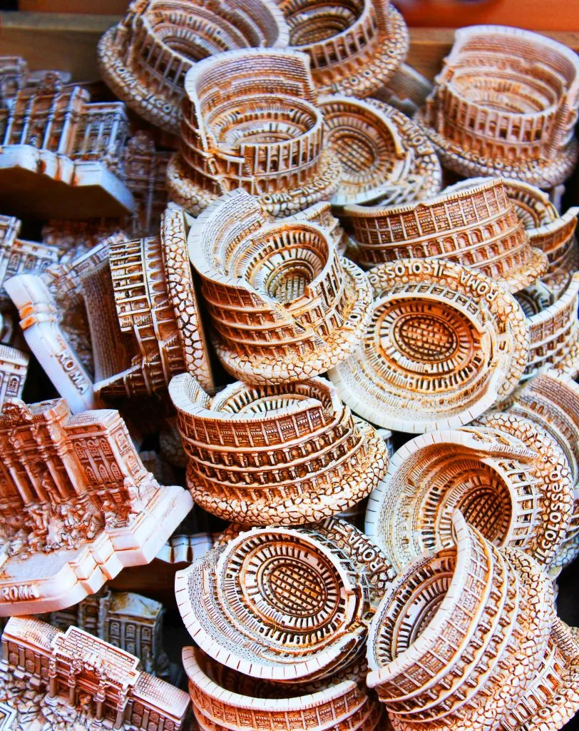 pile of colosseum figurines for sale as rome souvenirs