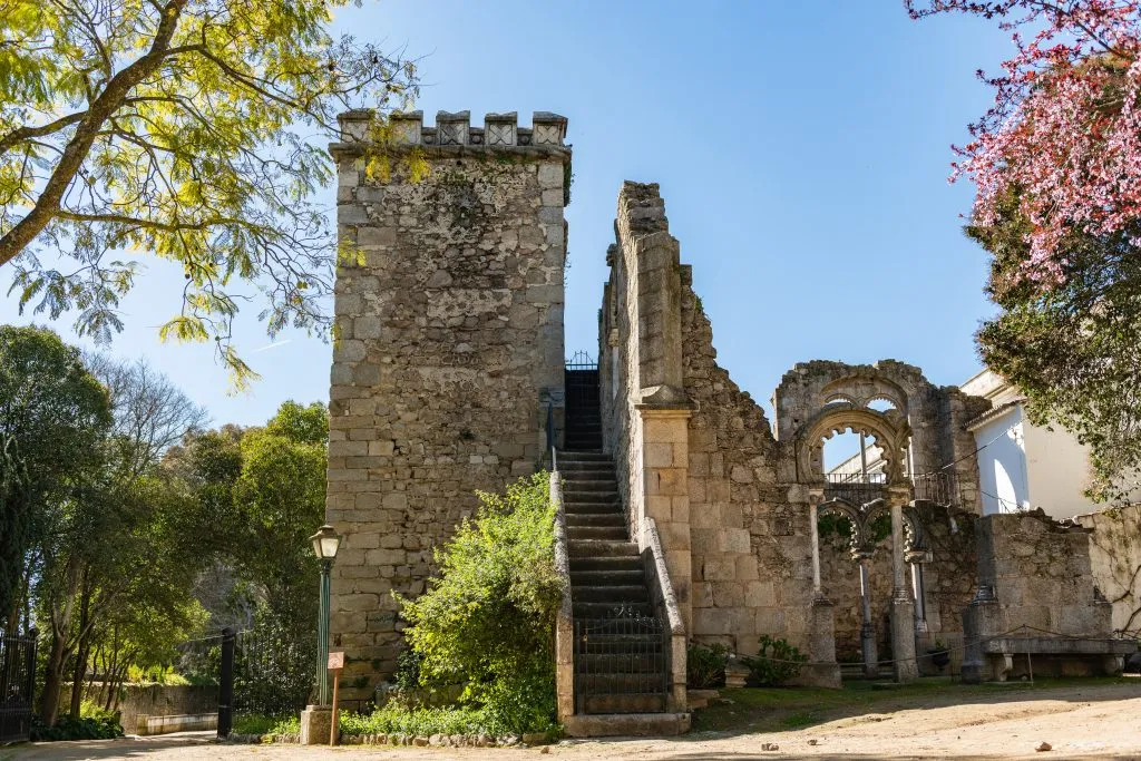 fake ruins in evora public garden featuring a tower and staircase