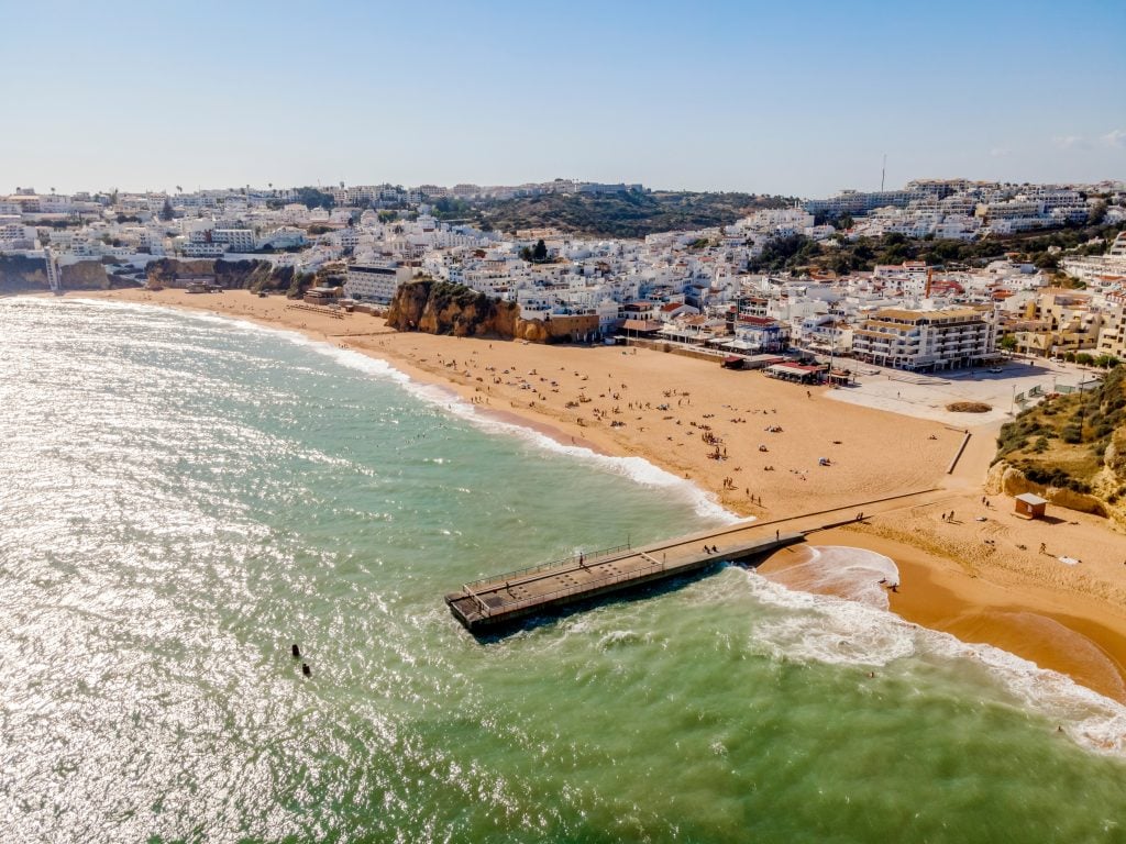 aerial view of albufeira portugal coastal town with water in the foreground